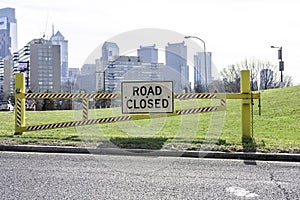 Road closed sign in Philadelphia with city in the background