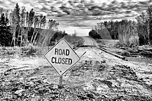 Road Closed sign posted by wood bridge