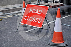 ROAD CLOSED sign with two traffic cones.