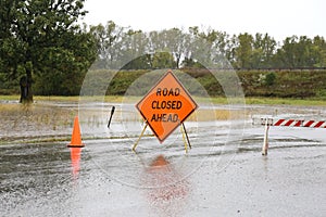 Road Closed Sign Warning of Rain Flooded Road