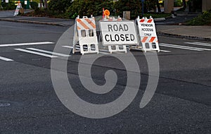 Road closed signs and barricades placed on a crosswalk