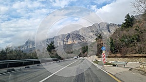 Road and clouds over mountains