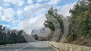 Road and clouds over mountains