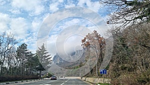 Road and clouds over mountains