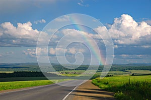 Road, clouds and rainbow