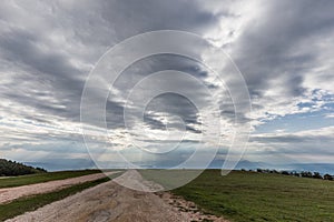 Road, clouds and sun rays