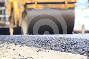 Road construction asphalt road by worker and roller machine. Asphalt road background