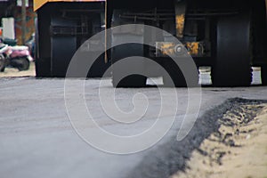 Road construction asphalt road by worker and roller machine. Asphalt road background