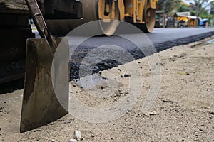 Road construction asphalt road by worker and roller machine. Asphalt road background