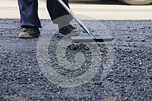 Road construction asphalt road by worker and roller machine. Asphalt road background