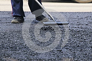 Road construction asphalt road by worker and roller machine. Asphalt road background