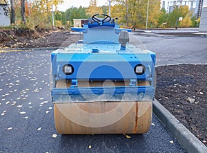 Road construction machinery. New asphalt roller. Replacement of the roadbed in the city. Road construction and laying.