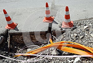 Road construction with pipes for laying optical fiber