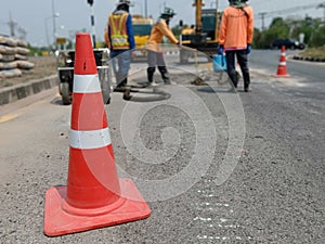Motion blur, road construction with a red rubber cone in front