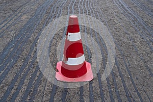 Road construction or repair - laying a new layer of asphalt, marking the level for increased accuracy and warning signs cone