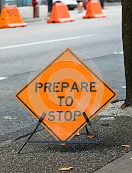 Road construction sign Prepare to Stop in a street of a city, selective focus on sign