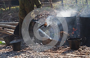 Road construction site with Asian worker making asphalt