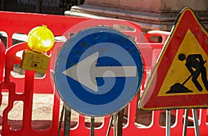 road construction site in the city and the signs with the big arrow and the flashing light