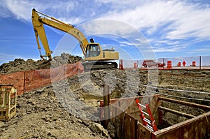 Road construction site with excavating machine