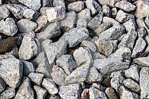 Road construction stone gravel granite stone Crushed rock close up. Small rocks ground. Crushed stone road building material