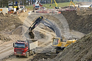 Road construction with truck and excavator
