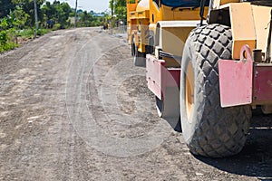 Road construction vehicle on the rough rural road.
