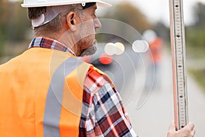 Road construction worker in orange vest an helmet