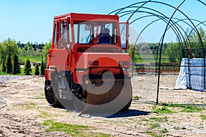 Road construction works with roller compactor machine