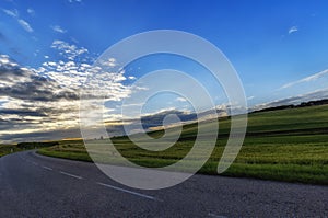 Road in the countryside on sunset background