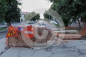 Road covered with concrete blocks and prohibitive sign