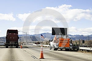 Road crew working on a busy freeway