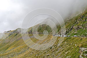 The road that crosses the Fagaras mountains seen from above among the fog, Transfagarasan, Romania