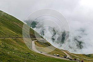 The road that crosses the Fagaras mountains seen from above among the fog, Transfagarasan, Romania