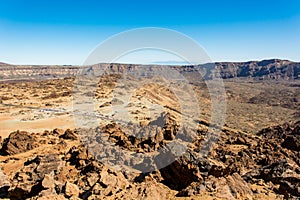 Road crossing spectacular lava shapped landscape in volcanic crater.