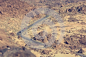 Road crossing spectacular lava shapped landscape in volcanic crater.