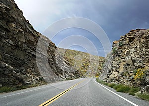 Road curve through mountains in california desert