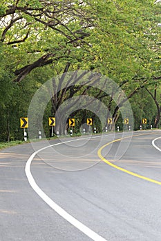 The road curve with street signs reflex light.