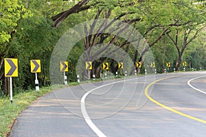 The road curve with street signs reflex light.