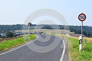 road curve into valley village Welling, with speed limit 50 early photo