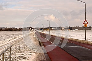Road and cycle path with winter landscape