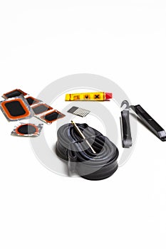 Road Cycling Concepts. Complete Set of Road Bike Inner Tube Repairing Kit Against White