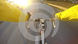 Road Cyclist POV. Male road cyclist riding his bicycle downhill on a asphalt road
