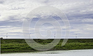 The road on the dam ridge has periodic light posts.