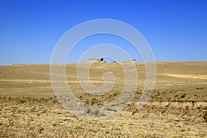 The road in the desert area of â€‹â€‹Uzbekistan. Buildings on the hill