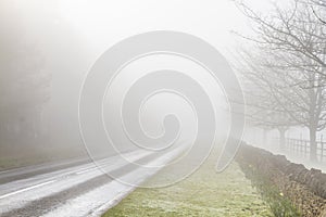 Road disappearing into fog photo