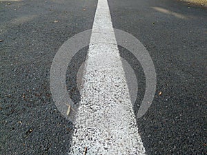 Road with a dividing strip, an original photo, gray texture