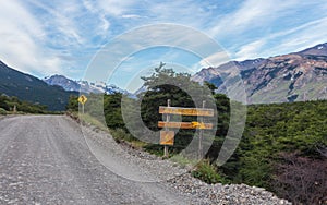 A road in El ChaltÃ©n city, and the signboard for the bikepath. Patagonia Argentina.