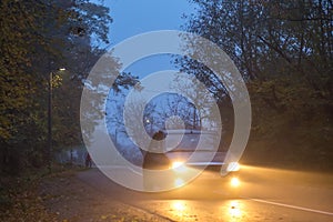 Road in the evening, autumn, fog, car on the road,
