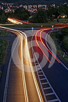 The road in the evening with light stripes headlights