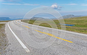 The road is far away against the background of stony hills